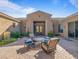 Relaxing front courtyard with comfortable seating, beautiful stonework, and front door access at 10829 E Volterra Ct, Scottsdale, AZ 85262