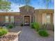 Elegant home entrance featuring custom stone work and landscaped walkway at 10829 E Volterra Ct, Scottsdale, AZ 85262