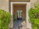 Charming front entrance, featuring decorative shrubbery and wrought iron gate at 10829 E Volterra Ct, Scottsdale, AZ 85262