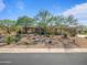 Inviting desert home with lush xeriscaping, mature trees, and charming curb appeal at 10829 E Volterra Ct, Scottsdale, AZ 85262