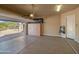 Well-lit garage with epoxy flooring and custom built-in cabinets at 10829 E Volterra Ct, Scottsdale, AZ 85262