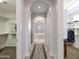 Hallway leading to Primary bathroom with walk in closet and chandelier at 10829 E Volterra Ct, Scottsdale, AZ 85262