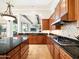 Well-equipped kitchen with tile backsplash, granite countertops and a seamless transition to the living area at 10829 E Volterra Ct, Scottsdale, AZ 85262