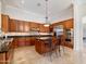 Kitchen with stainless steel appliances, granite countertops, wood cabinets, and kitchen island at 10829 E Volterra Ct, Scottsdale, AZ 85262