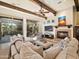 Comfortable living room with a fireplace, wooden beams, comfortable seating and lots of natural light at 10829 E Volterra Ct, Scottsdale, AZ 85262