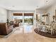 Inviting living area featuring tile floors, comfortable seating, and sliding glass doors to the backyard at 10829 E Volterra Ct, Scottsdale, AZ 85262