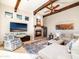 Inviting living room featuring wooden beams, a fireplace, and comfortable seating at 10829 E Volterra Ct, Scottsdale, AZ 85262