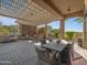 A beautiful outdoor living area features a fireplace, grill, dining area, and views of the desert at 10829 E Volterra Ct, Scottsdale, AZ 85262