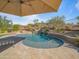 A refreshing pool under an umbrella, complemented by desert landscaping, offers a serene backyard retreat at 10829 E Volterra Ct, Scottsdale, AZ 85262