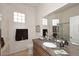 Well-lit bathroom featuring glass block windows, a vanity, and a bath and shower at 10960 N 78 St, Scottsdale, AZ 85260