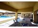 Spacious covered patio featuring outdoor seating, with views of the community pool at 10960 N 78 St, Scottsdale, AZ 85260