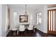 Bright dining room with a glass table, chandelier, and hardwood floors provides an elegant setting for meals at 10960 N 78 St, Scottsdale, AZ 85260