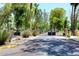 Gated entrance to the property, lined with mature trees and landscaping at 10960 N 78 St, Scottsdale, AZ 85260