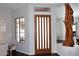 Elegant entryway featuring a wood door with glass inserts, adjacent to the formal dining area, and wood flooring at 10960 N 78 St, Scottsdale, AZ 85260