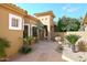 Inviting home featuring a beautiful stone courtyard, mature trees and plants, and desert landscaping at 10960 N 78 St, Scottsdale, AZ 85260