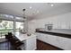 Bright kitchen featuring an island with seating, ample white cabinets, pendant lighting, and an adjacent breakfast area at 10960 N 78 St, Scottsdale, AZ 85260