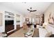 Inviting living room featuring wood floors, a fireplace, and seamless transition to dining and kitchen areas at 10960 N 78 St, Scottsdale, AZ 85260