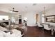 Open-concept living room featuring wood floors, a fireplace, and a seamless flow to dining and kitchen areas at 10960 N 78 St, Scottsdale, AZ 85260