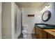 Well-lit bathroom with wood cabinets, green tiled countertops, and shower at 1205 W El Prado Rd, Chandler, AZ 85224