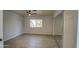 Bright bedroom features wood floors, window, ceiling fan, and mirrored closet at 1205 W El Prado Rd, Chandler, AZ 85224