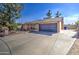 Home exterior featuring a two-car garage and mature landscaping at 1205 W El Prado Rd, Chandler, AZ 85224