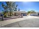 Beautiful one-story home with a brick facade, mature trees, and a spacious driveway at 1205 W El Prado Rd, Chandler, AZ 85224