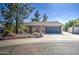 Charming single-story home with a two-car garage and mature landscaping at 1205 W El Prado Rd, Chandler, AZ 85224