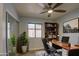 Well lit home office features a full bookcase and a large window at 1205 W El Prado Rd, Chandler, AZ 85224