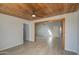 Bright living room features wood look tile, and a glimpse into another room at 1205 W El Prado Rd, Chandler, AZ 85224