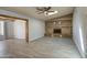 Neutral living room with skylight, brick fireplace and dining room access in a comfortable design at 1205 W El Prado Rd, Chandler, AZ 85224