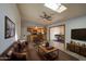 Bright living room with skylight, leather furniture, dining and kitchen access and modern ceiling fan at 1205 W El Prado Rd, Chandler, AZ 85224