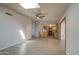 Light filled living room with skylight, neutral paint and flooring, and a peek into the kitchen at 1205 W El Prado Rd, Chandler, AZ 85224