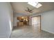 Bright, neutral living room with tile flooring, skylight, ceiling fan, kitchen and dining room access at 1205 W El Prado Rd, Chandler, AZ 85224