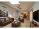 Comfortable living room with skylight, ceiling fan, fireplace, leather furniture and easy kitchen access at 1205 W El Prado Rd, Chandler, AZ 85224