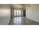 Spacious living room with wood-look tile and windows overlooking the front yard at 1205 W El Prado Rd, Chandler, AZ 85224