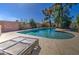 Backyard swimming pool with lounge chairs on the deck, perfect for relaxing in the sun at 1205 W El Prado Rd, Chandler, AZ 85224