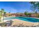 Backyard swimming pool featuring a deck, brick surround, and lounge furniture under a clear blue sky at 1205 W El Prado Rd, Chandler, AZ 85224