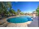 Backyard pool with a tanning ledge and mature trees surrounding the property at 1205 W El Prado Rd, Chandler, AZ 85224