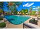 Inviting backyard pool with lounge seating, mature trees, and blue skies above at 1205 W El Prado Rd, Chandler, AZ 85224