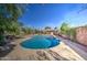 Backyard pool with a concrete deck, landscaping, brick trim, and a clear blue sky at 1205 W El Prado Rd, Chandler, AZ 85224