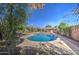 Backyard swimming pool featuring a concrete deck and mature trees providing shade and privacy at 1205 W El Prado Rd, Chandler, AZ 85224