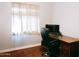 Bedroom space featuring a wood desk, computer, and a rolling office chair near a bright window at 13216 S 175 Dr, Goodyear, AZ 85338