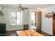 Inviting dining space with hardwood floors, plantation shutters, and a view of the front yard, next to the entry at 13216 S 175 Dr, Goodyear, AZ 85338