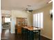 Charming dining area featuring hardwood floors, a vintage hutch, and bright natural light, perfect for Gathering meals at 13216 S 175 Dr, Goodyear, AZ 85338