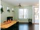 Cozy dining area with hardwood floors, natural light, and views of the landscaped front yard and inviting entryway at 13216 S 175 Dr, Goodyear, AZ 85338