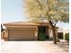 Single-story home featuring a two-car garage, desert landscaping and a mature tree in the front yard at 13216 S 175 Dr, Goodyear, AZ 85338