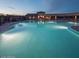 Enjoy a refreshing evening swim in this community pool and clubhouse under the dusky sky at 13216 S 175 Dr, Goodyear, AZ 85338