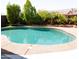 Inviting backyard pool surrounded by mature landscaping and a decorative concrete patio, perfect for outdoor relaxation at 13216 S 175 Dr, Goodyear, AZ 85338