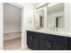 Stylish bathroom features a dual sink vanity with modern fixtures, a walk-in closet, and wood-look flooring at 13244 N 54Th Dr, Glendale, AZ 85304