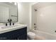 Bathroom featuring white subway tile in the shower, dark vanity, black fixtures, and a modern mirror at 13244 N 54Th Dr, Glendale, AZ 85304